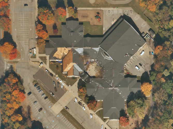 Near Space Labs' 10 cm capture of a building with missing roofing tiles, undergoing tile replacement.